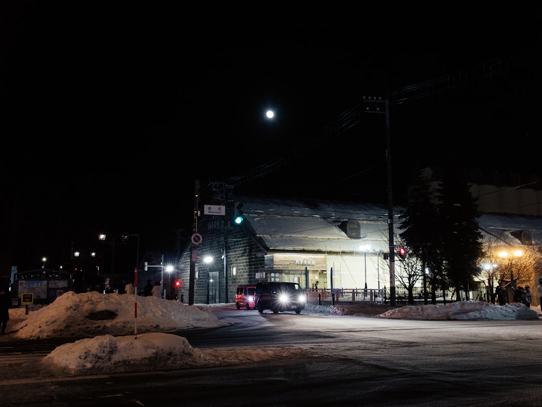 a city street at night with snow on the ground