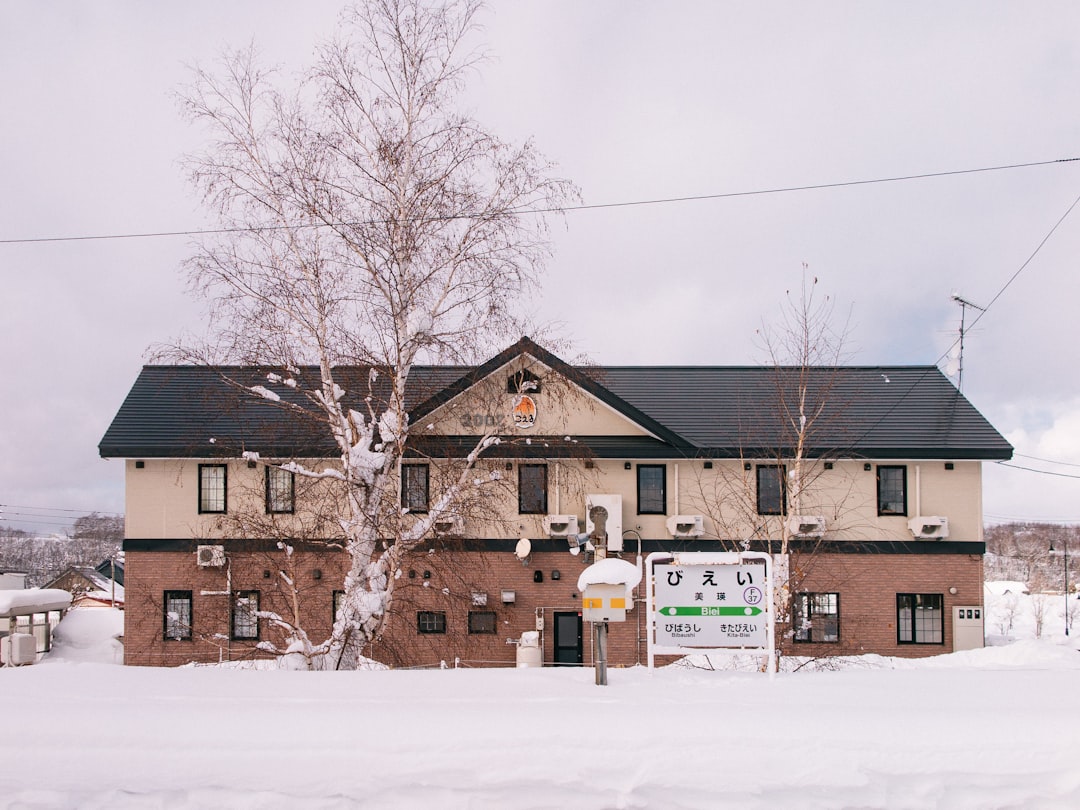 a building with a sign in front of it in the snow
