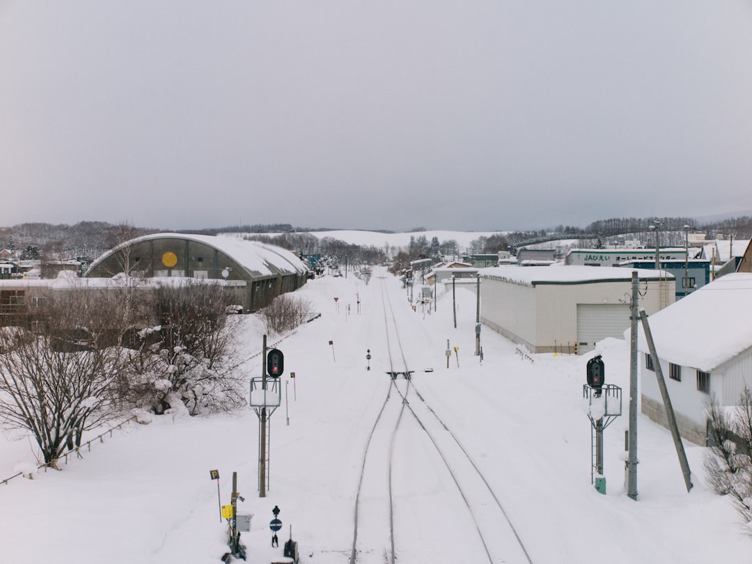 a train track running through a snow covered town