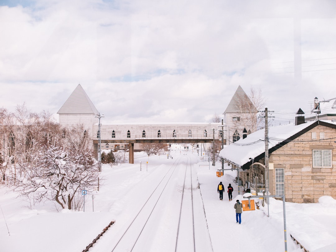 a train traveling down tracks next to a train station