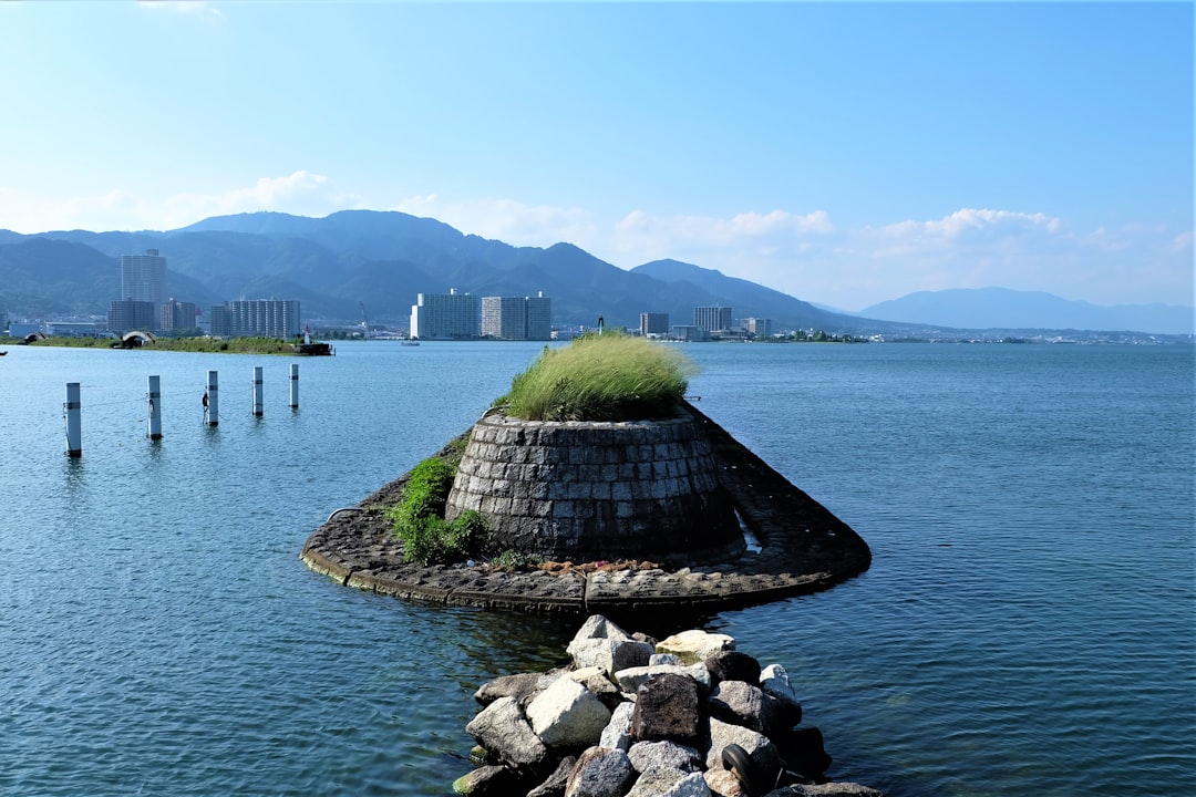 gray concrete bridge over blue sea during daytime