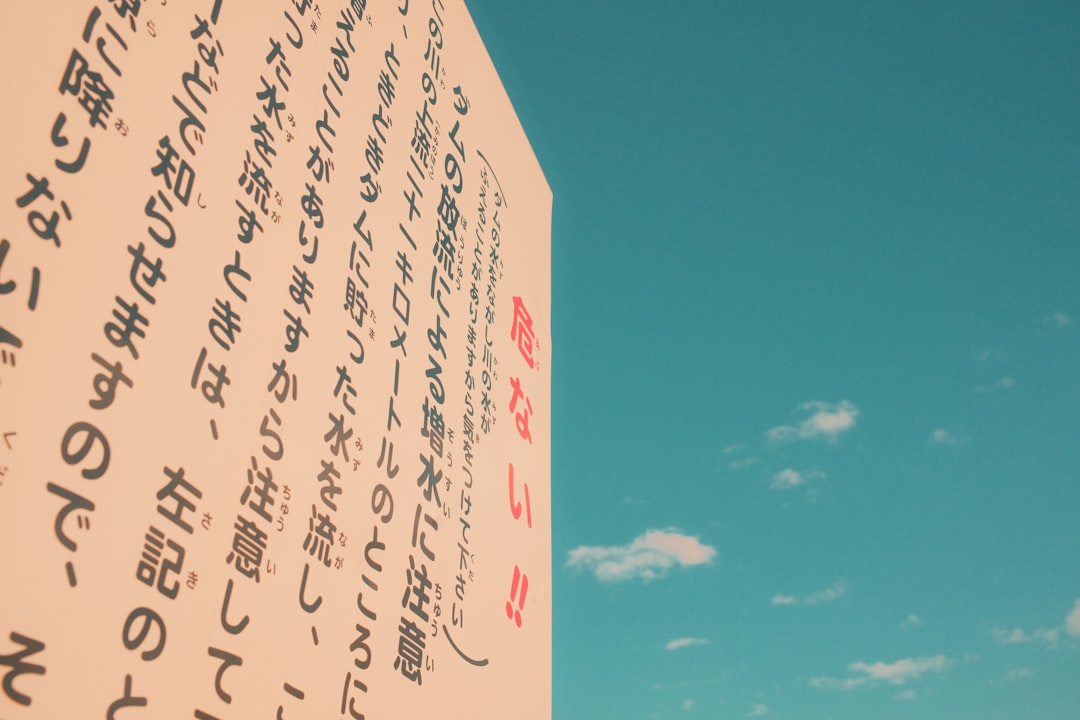 a close up of a street sign with a sky background