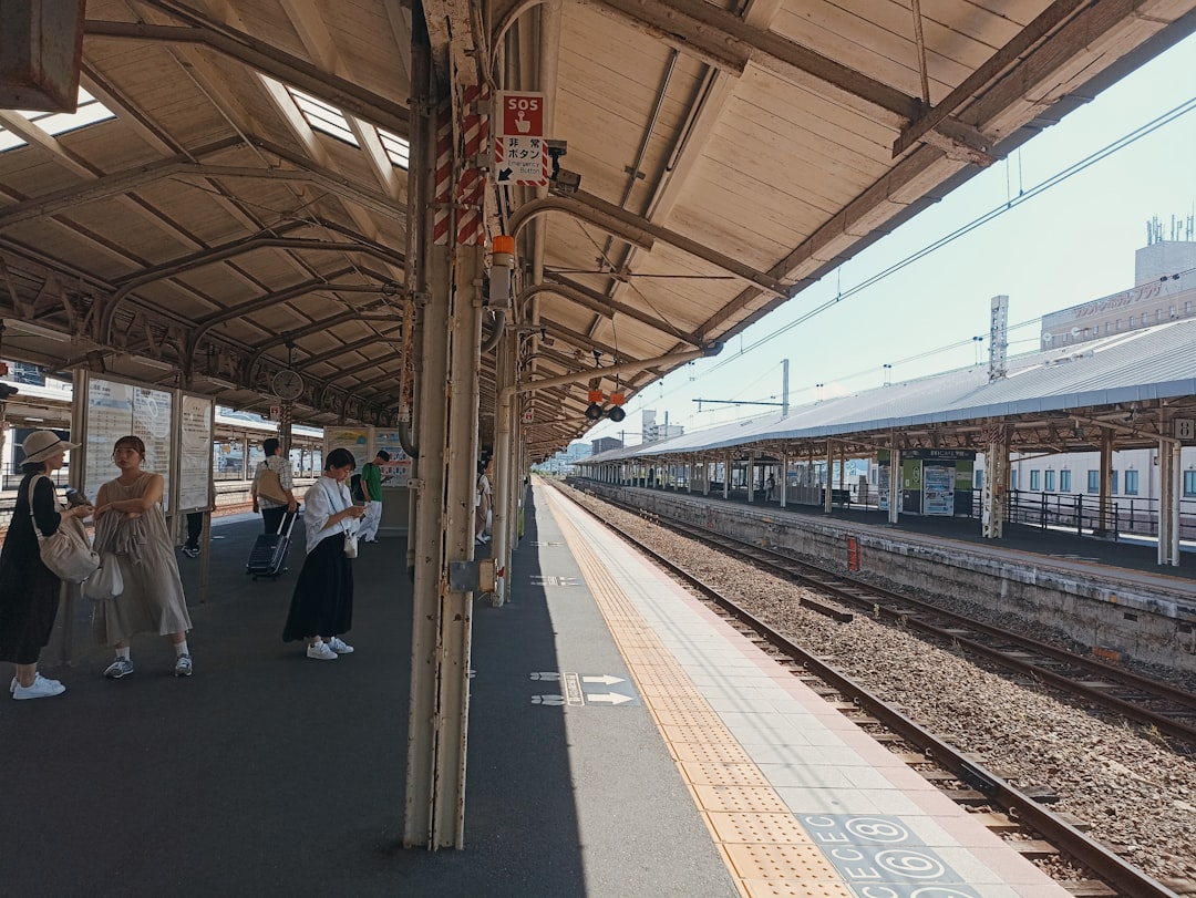 a group of people waiting for a train at a train station