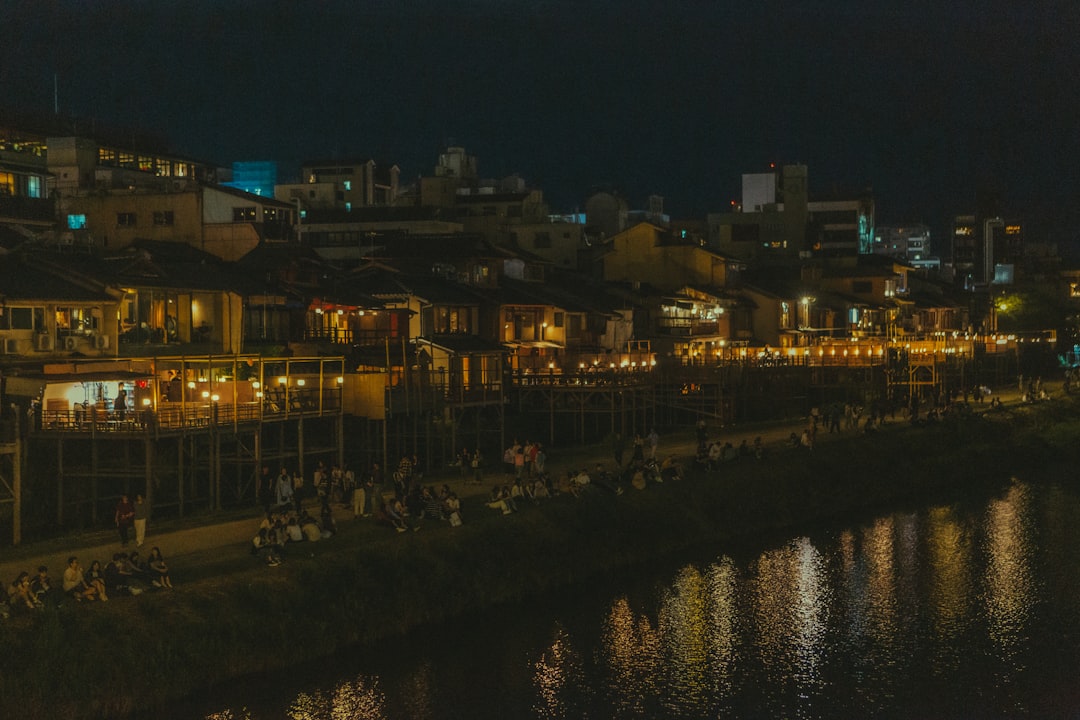 A night view of a river with a city in the background