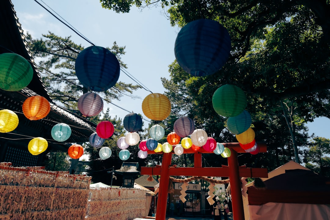 a bunch of paper lanterns hanging from a line