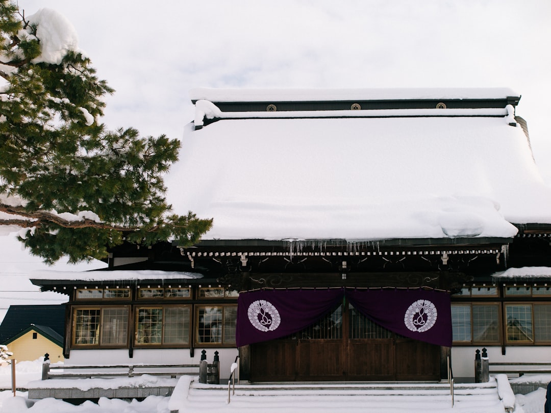 a building covered in snow with a purple flag