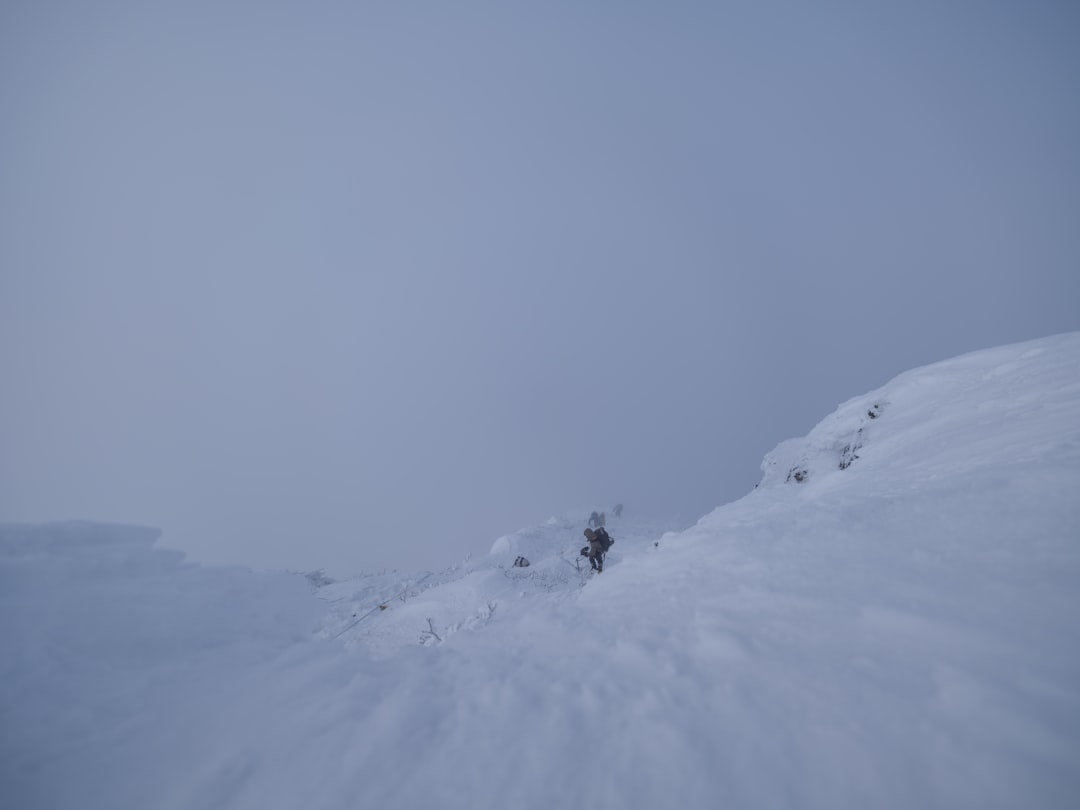 A person skiing down a snow covered mountain